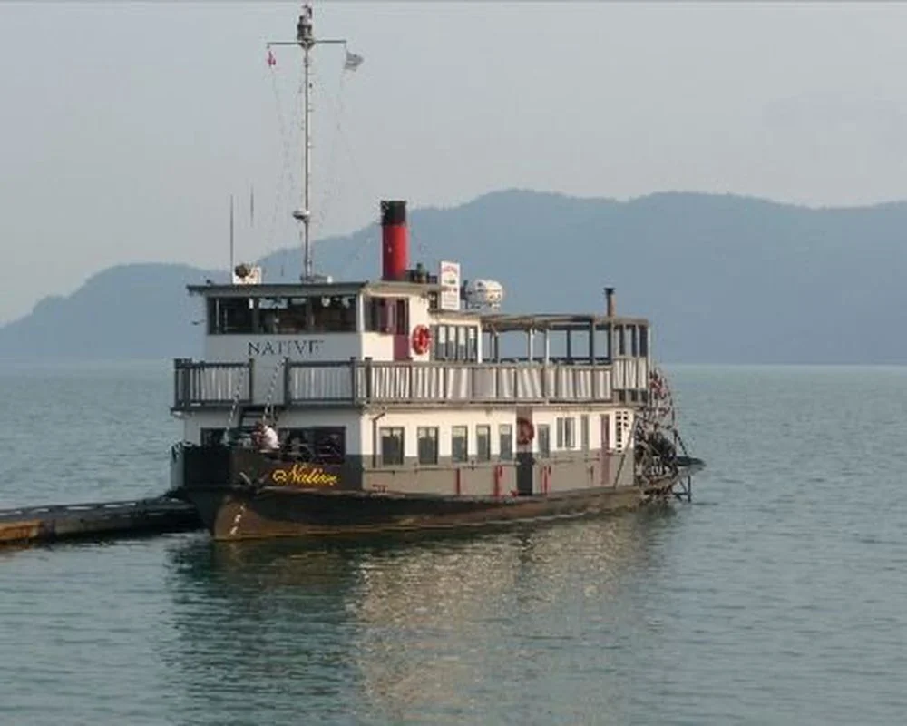 MV Native docked with mountains and calm water